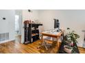 Bright home office space with hardwood flooring, a desk, and an adjacent bathroom at 1284 Piedmont Ne Ave # 12, Atlanta, GA 30309