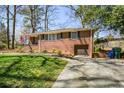 Charming one-story brick home with a well-manicured lawn and attached garage at 2780 Eastfield Se Rd, Smyrna, GA 30080