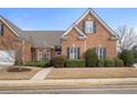 Charming brick home featuring symmetrical design, manicured landscaping, and a welcoming entrance at 348 Lauren Ln, Woodstock, GA 30188