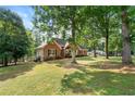 Beautiful brick home with a well-maintained lawn and mature trees enhancing the property's curb appeal at 587 Morgan Ct, Hampton, GA 30228