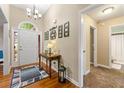 Welcoming foyer featuring hardwood floors, high ceilings, and a stylish entryway table at 587 Morgan Ct, Hampton, GA 30228