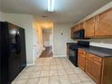 Kitchen with black appliances and wood cabinets at 105 Kentwood Springs Dr, Hampton, GA 30228