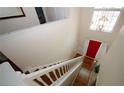 Bright foyer with hardwood floors, grand staircase, high ceilings and a vibrant red front door visible from the second story at 11532 Ethan Ct, Hampton, GA 30228