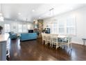 Spacious living room with hardwood floors, stone fireplace, ample seating, and natural light at 341 Little Pine Ln, Woodstock, GA 30188