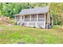 Charming cottage-style home featuring a screened front porch and a lush, wooded lot at 4481 Mclain Cir, Acworth, GA 30101
