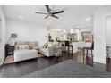 Open concept living area featuring dark hardwood floors, a modern ceiling fan, and seamless flow to the kitchen at 2336 Mark Trl, Decatur, GA 30032