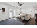 Well-lit living room boasts hardwood floors, a plush gray sofa, and stylish French doors at 2336 Mark Trl, Decatur, GA 30032