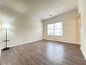 Inviting living room with hardwood floors, neutral paint, and a bright window at 3060 Scepter Dr, Duluth, GA 30096