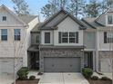 Charming townhouse with stone accents, a two-car garage and manicured landscaping at 3266 Spicy Cedar Ln, Lithonia, GA 30038