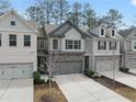 Beautiful townhouse with stone accents, gray siding, and a two-car garage at 3266 Spicy Cedar Ln, Lithonia, GA 30038