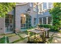 Charming outdoor courtyard with stone pavers and a wooden table at 455 Peachtree Battle Nw Ave, Atlanta, GA 30305