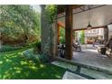 Relaxing outdoor patio with stone columns, comfortable seating, and a view of the backyard at 455 Peachtree Battle Nw Ave, Atlanta, GA 30305