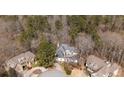 A high angle showing the home nestled amongst a quiet neighborhood with mature trees at 1458 Sweet Bottom Cir, Marietta, GA 30064