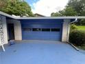 Garage with a large blue door, blue driveway, and exterior in need of TLC at 2323 Valleyside Dr, Decatur, GA 30032