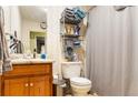 Functional bathroom with a single sink vanity, toilet, and shower-tub combo at 378 Cole Sw Dr, Lilburn, GA 30047