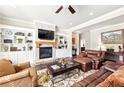 Cozy living room with fireplace, built-in shelving, and comfortable seating at 504 Taymack Farm Ct, Woodstock, GA 30188