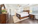 Serene main bedroom features tray ceiling, dark wood furniture, and ample natural light at 504 Taymack Farm Ct, Woodstock, GA 30188