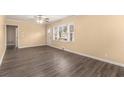 Bright living room boasts hardwood floors, neutral paint, and a large window for natural light at 1883 Windsor Sw Dr, Atlanta, GA 30311