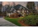 Beautiful two-story home with a combination of stone and stucco exterior, manicured lawn and mature landscaping at 2502 Oak Hill Ovlk, Duluth, GA 30097
