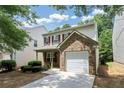 Two-story home featuring red shutters, brick accent, single car garage, and well-maintained landscaping at 4678 Ravenwood Loop, Union City, GA 30291