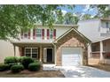 Charming home with red shutters, covered porch, brick detail, and a single car garage at 4678 Ravenwood Loop, Union City, GA 30291