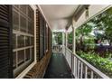 View of the long front porch, showing the exterior brick of the house and white railing at 745 Queen Ann Ct, Stone Mountain, GA 30083