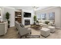 Bright living room with a fireplace, built-in shelving, stylish furniture, and ample natural light from large windows at 780 Mccart Rd, Lawrenceville, GA 30045
