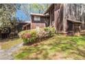 Unique townhome with weathered wood siding and mature landscaping at 4 Quail Run, Decatur, GA 30035