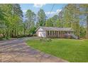 Beautiful single-story home with a long drive, attached garage, and well-maintained lawn and landscaping at 567 Shiloh Nw Rd, Kennesaw, GA 30144