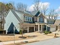 Beautiful two-story home with brick accents, a two-car garage, manicured landscaping, and inviting curb appeal at 1599 Benham Dr, Snellville, GA 30078