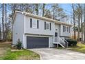 Two-story home with gray siding, black shutters, a two-car garage, and mature trees at 3456 Lenora Church Rd, Snellville, GA 30039