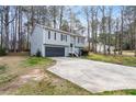 Two-story home with gray siding, black shutters, two-car garage, and an inviting front entrance at 3456 Lenora Church Rd, Snellville, GA 30039
