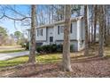 View of the two-story home featuring gray siding, black shutters, and a well-maintained lawn at 3456 Lenora Church Rd, Snellville, GA 30039
