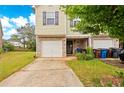 Inviting home featuring a single-car garage, cozy front porch, and a well-manicured lawn at 905 Magnolia Gardens Walk, Mcdonough, GA 30253