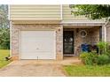 Close up of the exterior, showing the garage, front door, and surrounding brickwork at 905 Magnolia Gardens Walk, Mcdonough, GA 30253
