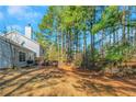 Large backyard surrounded by mature trees, creating a private and serene outdoor space at 3268 Rivermist Cv, Decatur, GA 30034