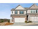 Two-story home with a brick facade, attached garage, and well-maintained landscaping at 355 Cherryhill Ln, Woodstock, GA 30188