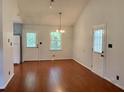 Bright dining area featuring wood floors, a chandelier, and views of the backyard through a window at 2921 Oakwilde Ct, Snellville, GA 30039