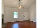 Inviting living room with a vaulted ceiling, wood floors, and a large window providing natural light at 2921 Oakwilde Ct, Snellville, GA 30039