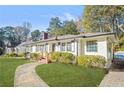 This property features lush landscaping with beautiful stone walkway leading to the charming entryway at 1403 Centra Villa Dr, Atlanta, GA 30311