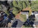 An aerial view shows a well-maintained home with a long driveway surrounded by lush greenery at 2931 Oakwilde Ct, Snellville, GA 30039