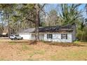 A cozy one-story house with white siding, a well-kept lawn, and a car parked in the driveway at 2931 Oakwilde Ct, Snellville, GA 30039