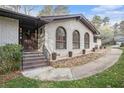 Inviting front entrance with a brick walkway, arched windows and a beautifully crafted wooden door at 4551 Cherie Glen Trl, Stone Mountain, GA 30083