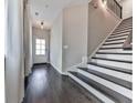 Inviting entryway features hardwood floors, staircase with modern black railing, and abundant natural light through the front door at 1020 Broadview Dr, Marietta, GA 30062