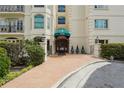 Beautiful condominium building entrance with manicured landscaping and covered doorway at 3636 Peachtree Ne Rd # 405, Atlanta, GA 30319