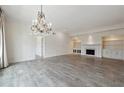 Expansive living room featuring beautiful flooring, a chandelier, and built-in shelving with a fireplace at 3636 Peachtree Ne Rd # 405, Atlanta, GA 30319