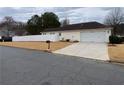 Well-maintained home showcasing a fenced backyard and a two-car garage at 5148 Centennial Creek Nw Vw, Acworth, GA 30102