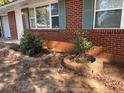 View of the front of the home showing updated landscaping in the front yard at 687 N Hairston Rd, Stone Mountain, GA 30083