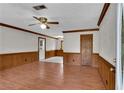 Spacious living room with wood trim, ceiling fan, and hardwood flooring at 881 Brighton Dr, Lawrenceville, GA 30043