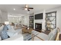 Open-concept living room featuring hardwood floors, a fireplace, and modern furnishings at 1286 Brookins Trl, Atlanta, GA 30316